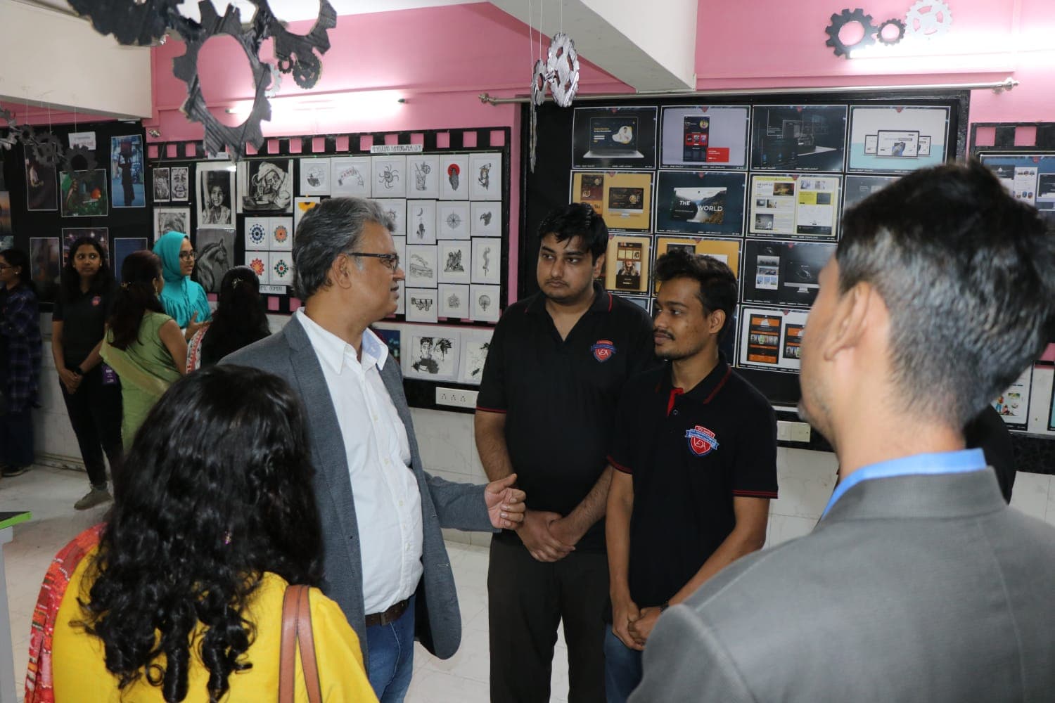 In discussion with students in front of their exhibited design projects